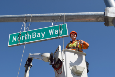 Marc York of Vacaville Public Works gives the thumbs up after installing a new NorthBay Way sign.